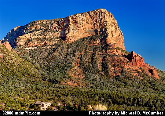 Red Mesa with a White Top Rock Facing a Setting Sun Picture